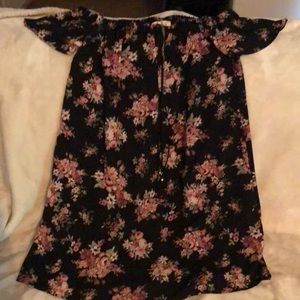 New, without tags, small black dress with floral print. Comes with a necklace.